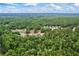 Aerial view of the neighborhood shows lush tree coverage and a view of several residential homes at 4267 Matisse Ln, Fairburn, GA 30213
