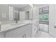 Bright bathroom featuring a double vanity with stone countertop, modern fixtures, and white cabinetry at 4267 Matisse Ln, Fairburn, GA 30213