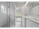 Bathroom showcasing a glass-enclosed shower, double vanity with stone countertop, and light-filled interior at 4267 Matisse Ln, Fairburn, GA 30213