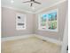 Bright bedroom with two windows offering natural light, ceiling fan, and neutral paint at 4267 Matisse Ln, Fairburn, GA 30213