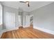 Light-filled bedroom with hardwood floors, neutral walls, and access to an ensuite bathroom and hallway at 4267 Matisse Ln, Fairburn, GA 30213