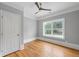 Bedroom with hardwood floors, gray walls, white trim, and a fan at 4267 Matisse Ln, Fairburn, GA 30213