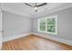 Bright bedroom with hardwood floors, a ceiling fan, and a large window bringing in ample natural light at 4267 Matisse Ln, Fairburn, GA 30213