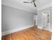 Bedroom featuring wood floors, gray walls, a ceiling fan, and an open door into another room at 4267 Matisse Ln, Fairburn, GA 30213