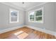 Bright bedroom with hardwood floors, two large windows, and neutral paint at 4267 Matisse Ln, Fairburn, GA 30213