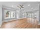 Large bonus room with hardwood floors, neutral walls, ceiling fan, and natural light at 4267 Matisse Ln, Fairburn, GA 30213