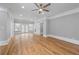 Large bonus room with hardwood floors, neutral walls, ceiling fan, and French doors at 4267 Matisse Ln, Fairburn, GA 30213