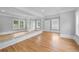 Bonus room featuring hardwood floors, large mirrors for activities, and natural light at 4267 Matisse Ln, Fairburn, GA 30213