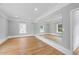 Bright bonus room featuring hardwood floors and a large mirror for exercise and activities at 4267 Matisse Ln, Fairburn, GA 30213