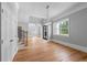 Open dining area featuring hardwood floors, elegant lighting, and a view of the staircase at 4267 Matisse Ln, Fairburn, GA 30213
