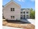 Two-story home with light-colored brick exterior, manicured lawn and long driveway at 4267 Matisse Ln, Fairburn, GA 30213