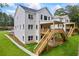 Spacious white brick home with a multi-level wooden deck, and lush landscaping in the backyard at 4267 Matisse Ln, Fairburn, GA 30213