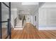 Light-filled foyer featuring hardwood floors, staircase with iron railings, and elegant wall trim at 4267 Matisse Ln, Fairburn, GA 30213