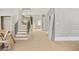 Inviting foyer with a wooden staircase featuring wrought iron railings and hardwood floors at 4267 Matisse Ln, Fairburn, GA 30213