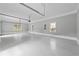 Spacious three-car garage with epoxy floors and modern doors with windows at 4267 Matisse Ln, Fairburn, GA 30213