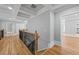 Hallway with wood floors, coffered ceilings, rod iron and wood railings and lots of natural light at 4267 Matisse Ln, Fairburn, GA 30213