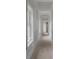 Long hallway with unfinished walls and multiple doors at 4267 Matisse Ln, Fairburn, GA 30213