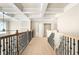 Upstairs hallway features coffered ceilings, wood floors, and a decorative metal railing at 4267 Matisse Ln, Fairburn, GA 30213