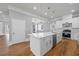 Bright, open kitchen featuring white cabinets, stainless steel appliances, and a center island at 4267 Matisse Ln, Fairburn, GA 30213