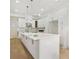 Modern kitchen with a large island, white cabinets, and pendant lighting fixtures at 4267 Matisse Ln, Fairburn, GA 30213