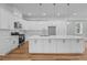 Elegant kitchen with white cabinets, marble countertops, stainless steel appliances, and hardwood floors at 4267 Matisse Ln, Fairburn, GA 30213