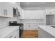 Modern kitchen features white cabinets, stainless steel appliances, and a marble backsplash at 4267 Matisse Ln, Fairburn, GA 30213