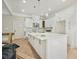 Modern kitchen with a large island, white cabinets, and pendant lighting fixtures at 4267 Matisse Ln, Fairburn, GA 30213