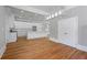 Modern kitchen featuring white cabinets, large island, stainless steel appliances, and pendant lighting at 4267 Matisse Ln, Fairburn, GA 30213
