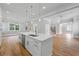Open-concept kitchen featuring an island, stainless steel dishwasher, and hardwood floors at 4267 Matisse Ln, Fairburn, GA 30213