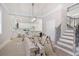 Bright room showcasing a staircase with wrought iron details and a kitchen with modern, white fixtures at 4267 Matisse Ln, Fairburn, GA 30213