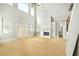 Bright living room with high ceilings, a fireplace, and large windows, offering natural light at 4267 Matisse Ln, Fairburn, GA 30213