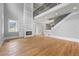 Cozy living room with high ceilings, a fireplace, and access to the staircase at 4267 Matisse Ln, Fairburn, GA 30213
