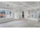Bright, spacious living room under construction featuring large windows and a set of French doors at 4267 Matisse Ln, Fairburn, GA 30213