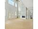 Bright living room with high ceilings, a fireplace, and large windows, offering natural light at 4267 Matisse Ln, Fairburn, GA 30213