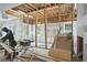 Under construction living room with exposed framing, new windows, and french doors leading to deck at 4267 Matisse Ln, Fairburn, GA 30213