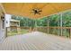 Covered porch with wood ceiling and railings overlooking a wooded area at 4267 Matisse Ln, Fairburn, GA 30213