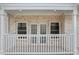 View of the front of the porch, showing white railings and brick columns at 4267 Matisse Ln, Fairburn, GA 30213