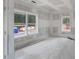 Room under construction with large windows, featuring a view of the outdoor landscape at 4267 Matisse Ln, Fairburn, GA 30213