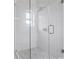 Modern glass shower featuring white tiling, a sleek showerhead, and unique floor tiles at 4267 Matisse Ln, Fairburn, GA 30213