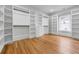 Spacious walk-in closet with wood floors and custom shelving at 4267 Matisse Ln, Fairburn, GA 30213