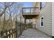 A stone backyard patio with a wooden deck, perfect for entertaining guests at 2669 Glenrose Hl, Atlanta, GA 30341