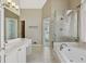 Bright bathroom featuring a glass shower, soaking tub, and double sink vanity at 2669 Glenrose Hl, Atlanta, GA 30341