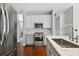 Kitchen with stainless steel appliances, marble countertops, and gray and white cabinets at 2669 Glenrose Hl, Atlanta, GA 30341