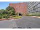 Brick building exterior with landscaped grounds and a curved driveway at 3060 Pharr Court North Nw # 109, Atlanta, GA 30305