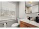 Modern bathroom with a toilet, sink, and shower at 3384 Campbell Se Rd, Smyrna, GA 30080