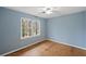 Light blue bedroom with large window and new flooring at 4745 Elam Forest Dr, Stone Mountain, GA 30083