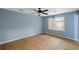 Light blue bedroom with new flooring and ceiling fan at 4745 Elam Forest Dr, Stone Mountain, GA 30083