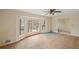 Living room with bay window, ceiling fan, and new flooring at 4745 Elam Forest Dr, Stone Mountain, GA 30083