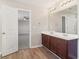 Double vanity bathroom with dark wood cabinets and vinyl flooring at 6897 Estepona St, Atlanta, GA 30349