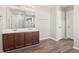 Double vanity bathroom with dark wood cabinets and vinyl flooring at 6897 Estepona St, Atlanta, GA 30349